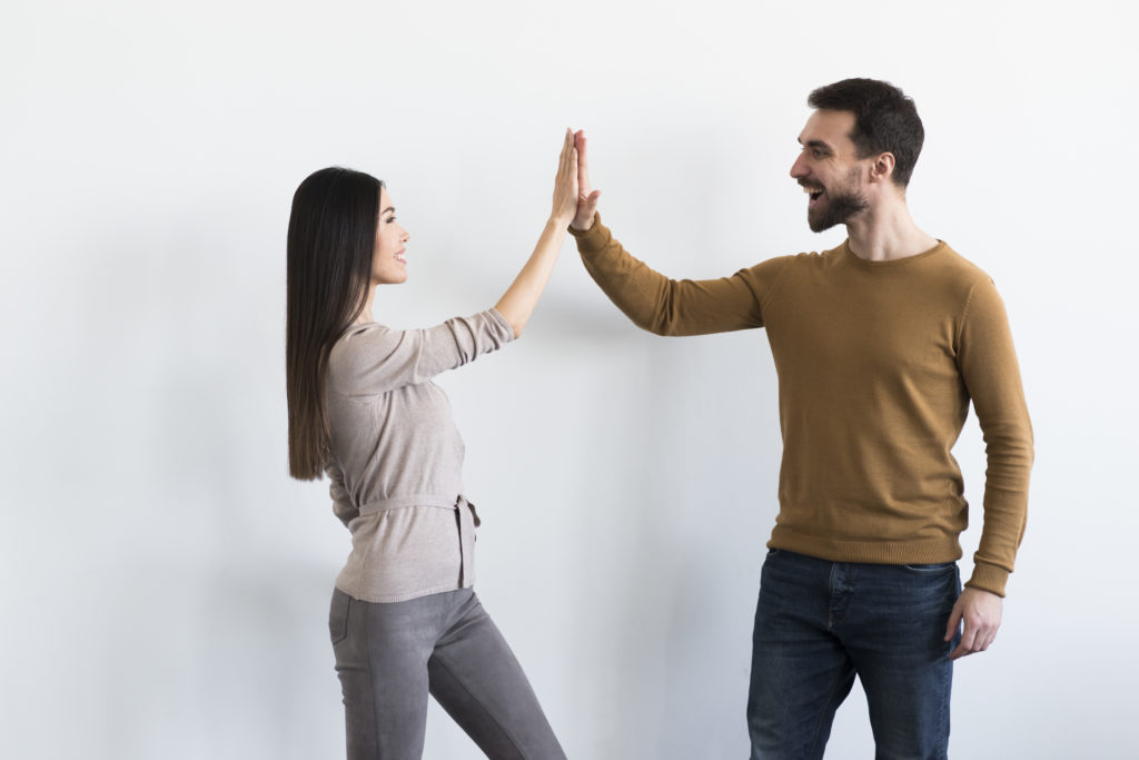 positive adult male young woman high fiving